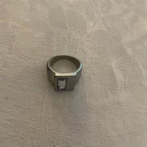 Metal ring with clear stone imbedded